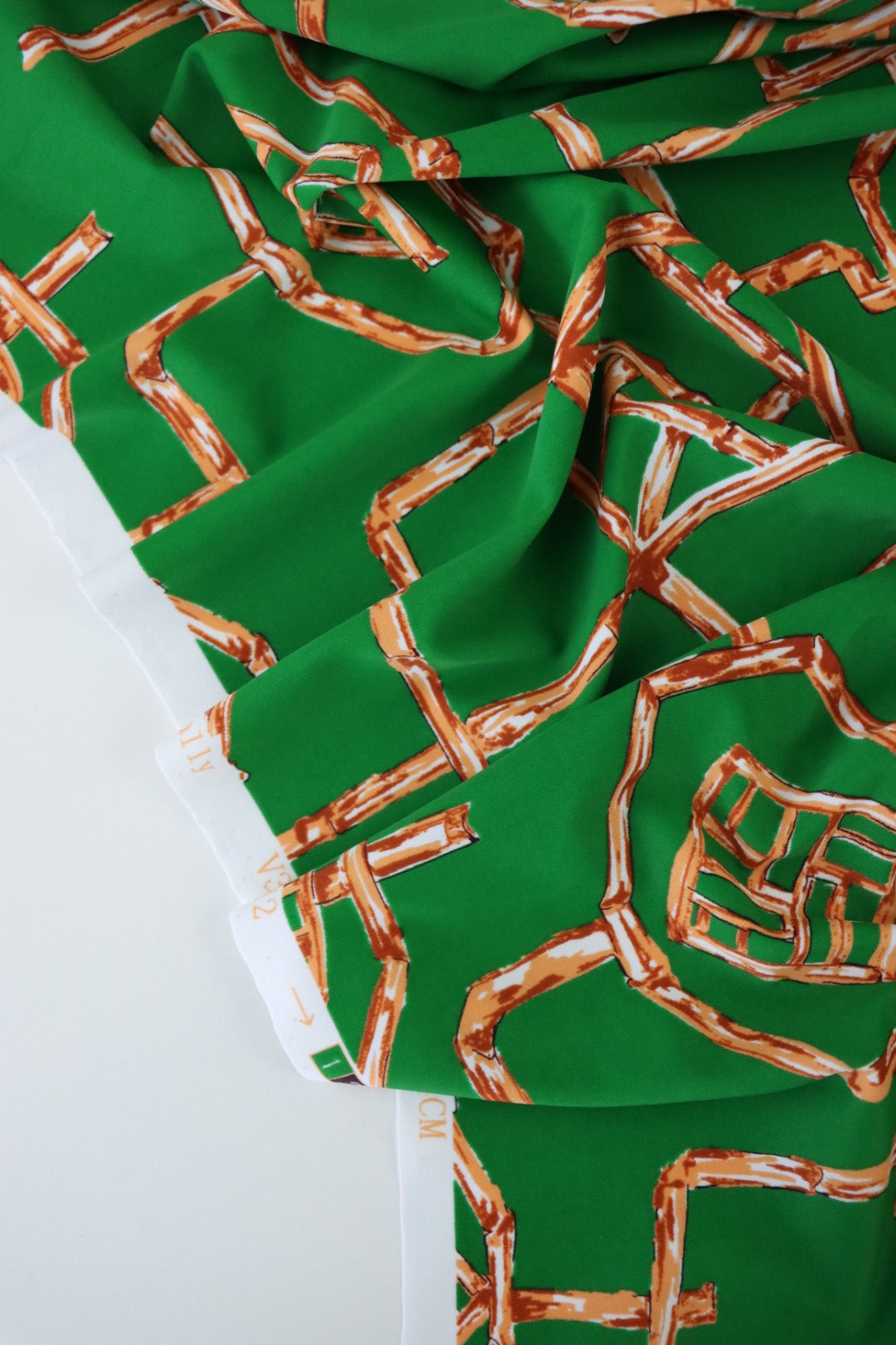 Orange Bamboo Lattice on Kelly Green Nylon Spandex Tricot | Designer Deadstock