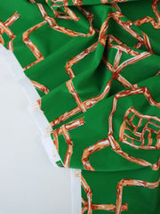 Load image into Gallery viewer, Orange Bamboo Lattice on Kelly Green Nylon Spandex Tricot | Designer Deadstock
