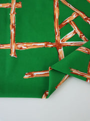 Load image into Gallery viewer, Orange Bamboo Lattice on Kelly Green Nylon Spandex Tricot | Designer Deadstock
