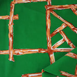Load image into Gallery viewer, 1YD PRECUT; Orange Bamboo Lattice on Kelly Green Nylon Spandex Tricot | Designer Deadstock
