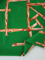 Load image into Gallery viewer, 1YD PRECUT; Orange Bamboo Lattice on Kelly Green Nylon Spandex Tricot | Designer Deadstock
