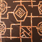 Load image into Gallery viewer, Rust Bamboo Lattice on Chocolate Nylon Spandex Tricot | Designer Deadstock
