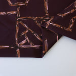 Load image into Gallery viewer, Bamboo Lattice on Dark Maroon Nylon Spandex Tricot | Designer Deadstock
