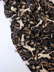 Load image into Gallery viewer, Leaping Leopards on Black Nylon Spandex Tricot | Designer Deadstock
