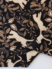 Load image into Gallery viewer, Leaping Leopards on Black Nylon Spandex Tricot | Designer Deadstock
