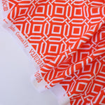 Load image into Gallery viewer, Intertwined on Orange Nylon Spandex Tricot | Designer Deadstock
