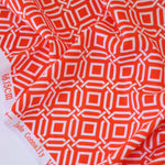 Load image into Gallery viewer, 1YD PRECUT; Intertwined on Orange Nylon Spandex Tricot | Designer Deadstock
