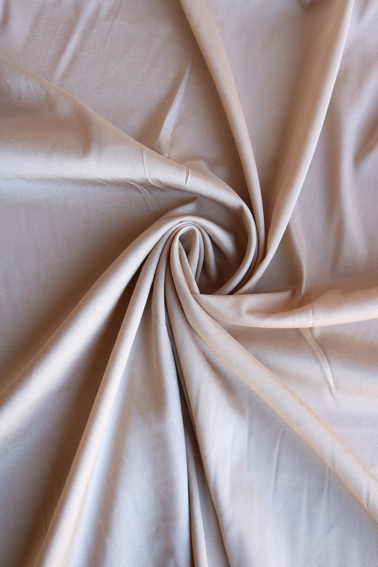 Texture, background, pattern. Light beige silk fabric for sewing clothes.  Crepe de chine Stock Photo