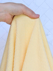 Load image into Gallery viewer, 1YD 19IN REMNANT; Pastel Yellow Smocked Jersey Knit